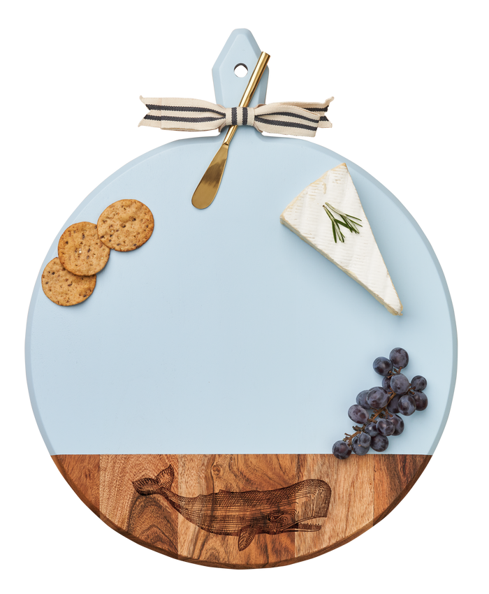The Maple Acacia Heirloom Board with Handle (Whale, 20 x 16") comes with a gold spreader tied with a gray & white ribbon, perfect for serving charcuterie like crackers, cheese, grapes, and more.