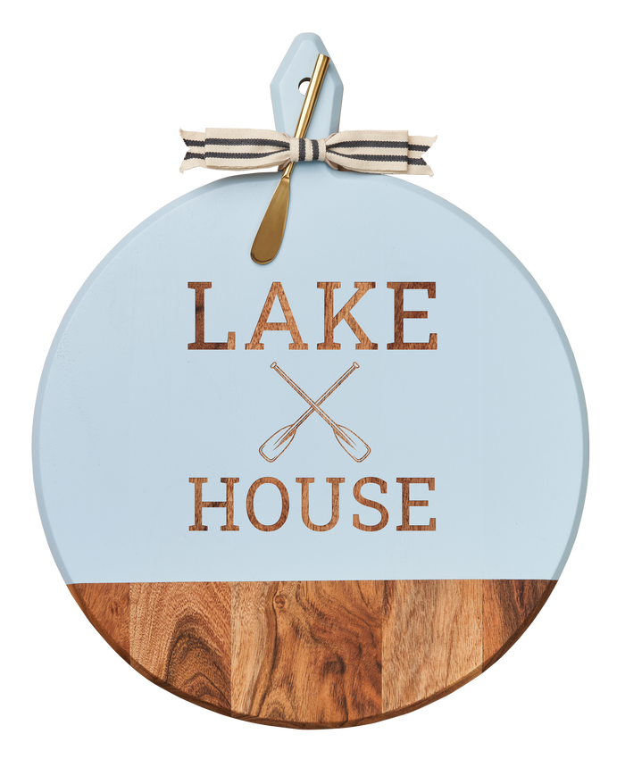 The Maple Acacia Heirloom Board with Handle features a round light blue top, "Lake House" and crossed oars engraving, a gray & white ribbon, and a gold spreader—perfect for serving bites at any gathering. Size: 20 x 16".