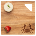 A round white cheese with rosemary and a strawberry rest on Maple’s Acacia Modern Geo Square | Crab | 12 x 12" serving board, featuring crab and triangle cutouts.