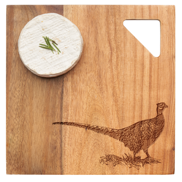 A round wheel of brie cheese with chives rests on the Maple Acacia Modern Geo Square 9 x 9" board, which features an engraved pheasant and a triangular corner cut-out.