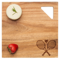 A round cheese with rosemary and a strawberry sits on Maple's Acacia Modern Geo Square 12"x12" wood board, featuring a tennis racket design and a triangular cut-out in one corner.