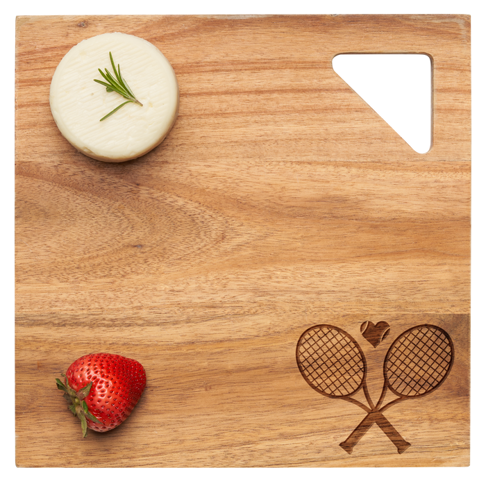 A round cheese with rosemary and a strawberry sits on Maple's Acacia Modern Geo Square 12"x12" wood board, featuring a tennis racket design and a triangular cut-out in one corner.