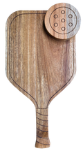 The Maple Acacia Pickleball Board | 16 x 9 features an ergonomic handle and a round engraved wooden pickleball detail—an ideal, paddle-shaped charcuterie board for pickleball fans.