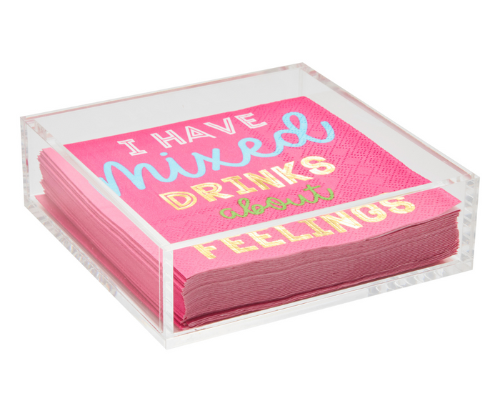 The Sophistiplate Acrylic Cocktail Napkin Tray - Clear is a modern tabletop essential, perfect for holding pink cocktail napkins with “I have mixed drinks about feelings” in colorful, metallic lettering.