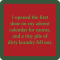 Red square with green text: I opened the first door on my Drinks On Me Advent Coaster and a tiny pile of dirty laundry fell out. Green border—great for fans of funny drink coaster humor or clever housewarming gifts.