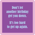 A purple square with a pink border shows light blue text: Don’t let another birthday get you down. It’s too hard to get up again—perfect for gifting or laughs with the Drinks On Me Coaster Bundle: Birthday.