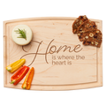 The Maple Arched Artisan Maple Board (12 x 9") engraved with “Home is where the heart is” displays a round rosemary-topped cheese, three seeded crispbreads, plus red and yellow bell pepper slices—a charming serving piece.