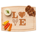 The Maple Arched Artisan Maple Board | Tennis LOVE | 12 x 9" displays cheese, multigrain crackers, and sliced bell peppers; its maple wood surface is engraved with LOVE in a tennis-themed design.