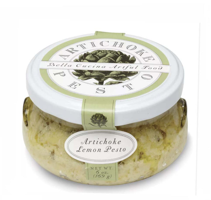 A 6 oz jar of Bella Cucina Artichoke Lemon Pesto, featured on Oprah’s Favorite Things, with a white lid and green label showcasing an artichoke design.