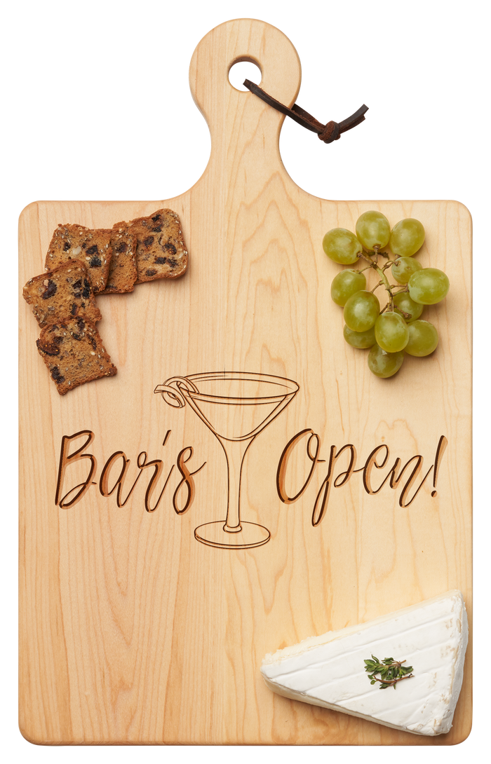 The Maple Artisan Maple Paddle Board | Bar's Open | 16 x 10" features "Bar’s Open!" and a martini glass engraving, styled with green grapes, crackers, and brie cheese topped with fresh herbs.