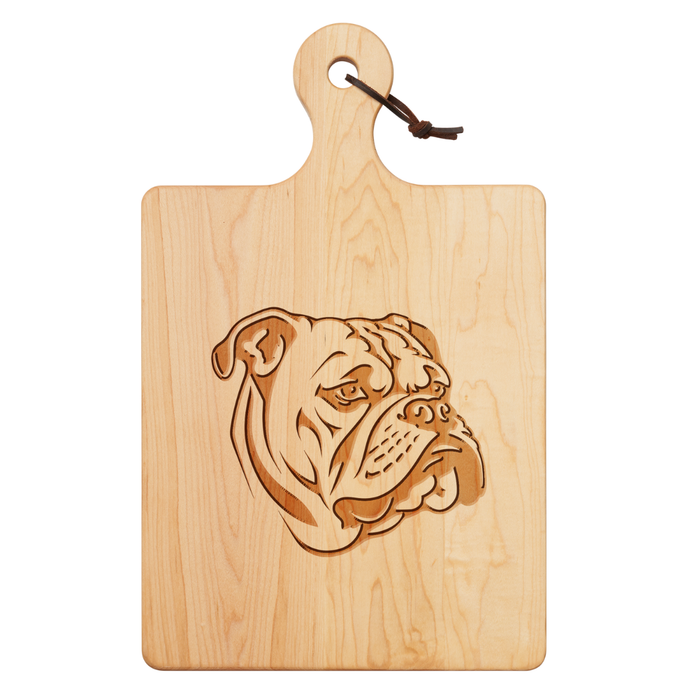 The Maple Artisan Maple Paddle Board | Bulldog | 16 x 10" features a carved bulldog head, a leather loop for hanging, and is perfect as a unique charcuterie or cutting board.