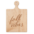 The Maple Artisan Maple Paddle Board (9 x 6") features a handle and "Fall Vibes" engraved in cursive on light maple wood.