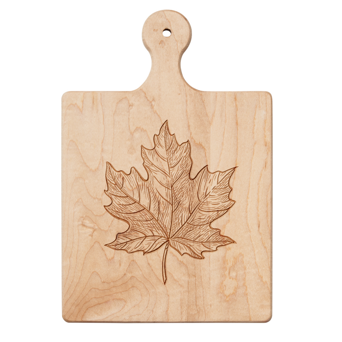 The Maple Artisan Maple Paddle Board | Maple Leaf | 9 x 6" is a light maple wood board with a handle and an engraved maple leaf design in the center.