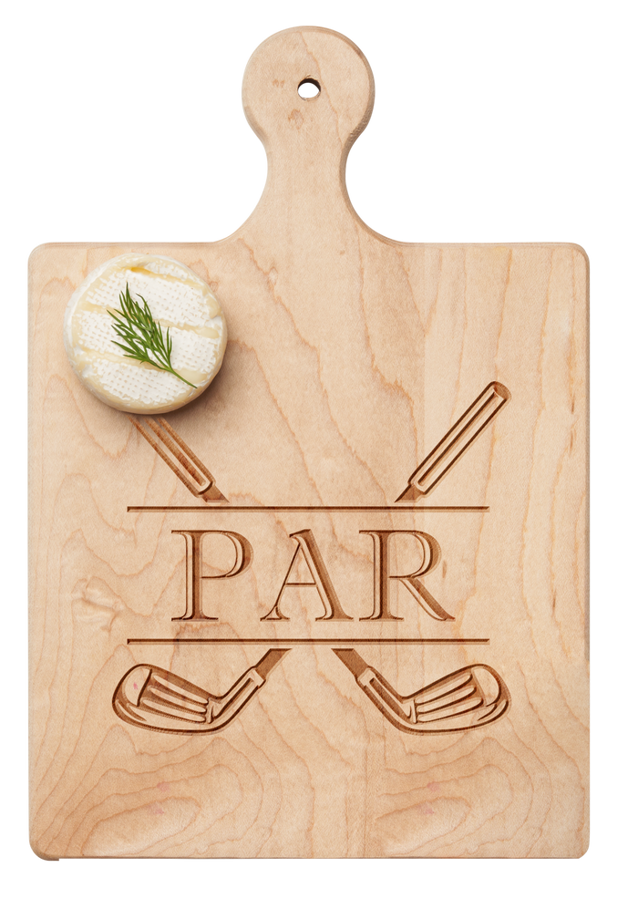 A round cheese with dill rests on the Maple Artisan Maple Paddle Board | Par (9" x 6"), which features two crossed golf clubs and the word "PAR" engraved on it.