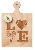 The Maple Artisan Maple Paddle Board | Tennis LOVE | 9" x 6" features LOVE engraved in maple, with a heart-shaped tennis ball as the “O” and two rackets as the “V.” A small herbed cheese round sits in the upper left corner.