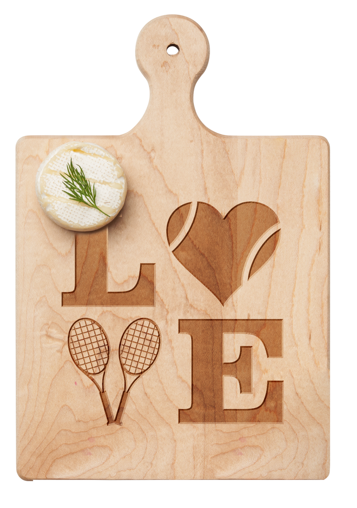 The Maple Artisan Maple Paddle Board | Tennis LOVE | 9" x 6" features LOVE engraved in maple, with a heart-shaped tennis ball as the “O” and two rackets as the “V.” A small herbed cheese round sits in the upper left corner.