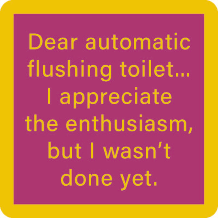 The Drinks On Me Automatic Flush Coaster features yellow text on a purple background with a thick yellow border, reading: "Dear automatic flushing toilet... I appreciate the enthusiasm, but I wasn’t done yet." Perfect for bar cart accessories.