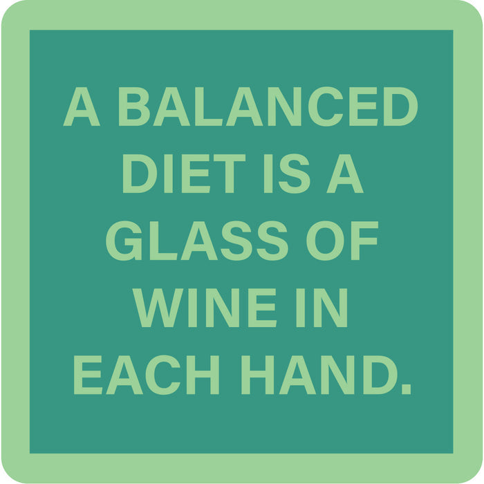 The Balanced Diet Coaster by Drinks On Me features the quote "A balanced diet is a glass of wine in each hand." Its green, playful design makes it an ideal bar cart accessory or a fun housewarming gift.