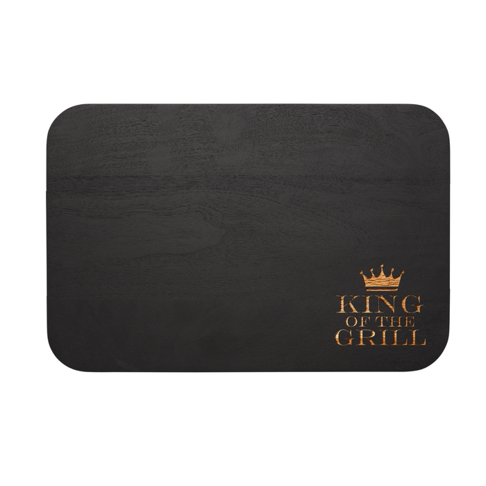 The Maple Black Acacia Wood Cutting + Cheeseboard (18 x 12", rounded corners) features a golden crown and “KING OF THE GRILL” text—ideal kitchen decor or for serving dishes in style.