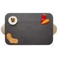 The Maple Black Acacia Wood Cutting + Cheeseboard w/ Gold Handles (18 x 12") holds a small round cheese, red and orange mini sweet peppers, and four crackers—ideal as an engraved board for stylish entertaining.