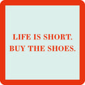 The Buy the Shoes Coaster by Drinks On Me features "LIFE IS SHORT. BUY THE SHOES." in bold red on a white square with a thick red border—making it a funny drink coaster and clever housewarming gift.
