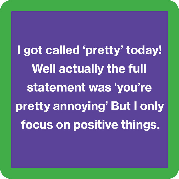 The Called Pretty Coaster by Drinks On Me features a purple square with a green border and the text: "I got called ‘pretty’ today! Well, actually ‘you’re pretty annoying’—but I focus on the positive." A hilarious drink coaster or unique hostess gift.