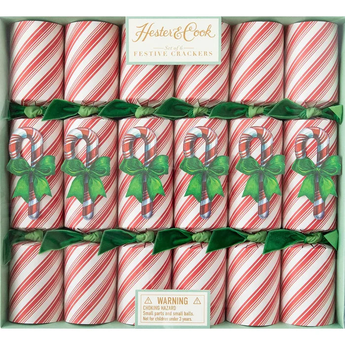 Hester & Cook Candy Cane Crackers feature red and white stripes, candy cane accents, and green bows. Perfect for party favors or table decor. Includes a warning about small parts.
