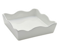 The Sophistiplate Ceramic Cocktail Napkin Tray is a white, square holder with wavy scalloped edges and smooth sides, shown angled against a plain background.
