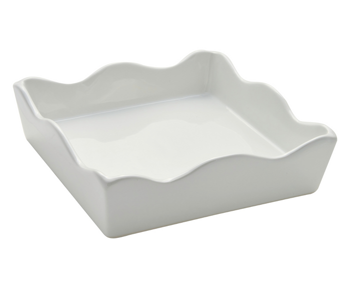 The Sophistiplate Ceramic Cocktail Napkin Tray is a white, square holder with wavy scalloped edges and smooth sides, shown angled against a plain background.