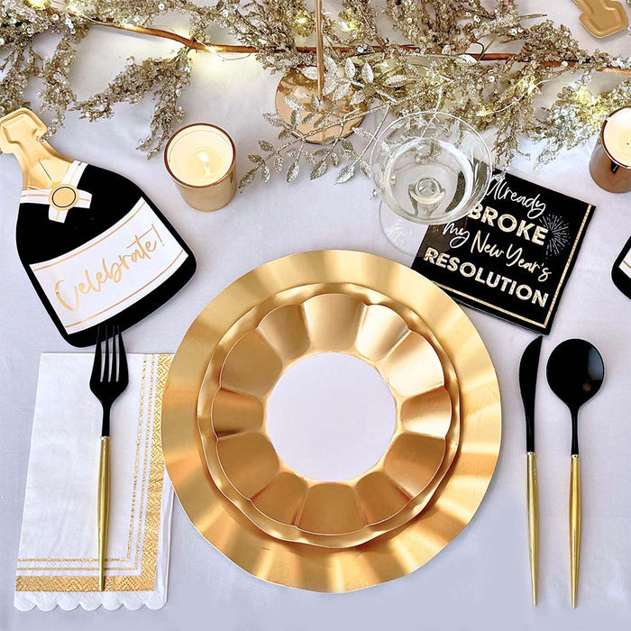 Create a festive table with the Sophistiplate Champagne Celebration Table Set, featuring designer plates, black and gold cutlery, a champagne bottle ‘Celebrate!’ decor, candles, themed napkin, and elegant gold accents.