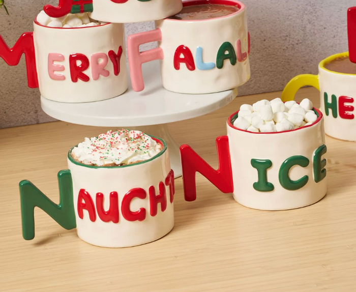 The Drinks On Me Christmas Coaster Bundle- Version 1 features festive coasters with MERRY, FALALA, NAUGHTY, and NICE—perfect for holiday gatherings or as a stocking stuffer.