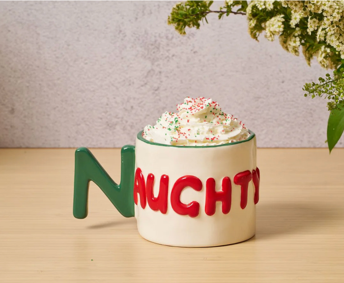 Enjoy a festive mug with a green N handle and red "NAUGHTY" letters, topped with whipped cream—perfect for gifting. Pair it with the Drinks On Me Christmas Coaster Bundle- Version 1 for a charming holiday set.