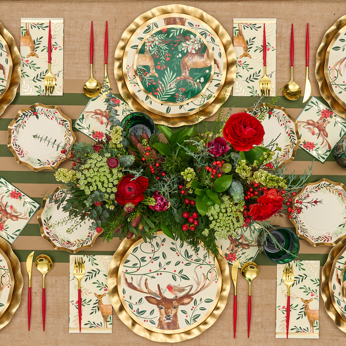 Create a festive tablescape with Sophistiplate’s Christmas Forest Salad Plates (8-pack), showcasing elegant gold rims and enchanting reindeer and foliage motifs. Pair them with gold cutlery, red candles, and a striking centerpiece of red roses and greenery atop a striped tablecloth for a stunning holiday setting.