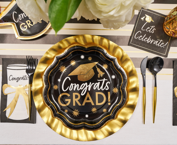 Create a festive graduation table with Sophistiplate’s Classic Grad Dinner Plates (8pk), adorned with a graduation cap design, paired with matching napkins, gold utensils, and white flowers—the perfect disposable plates for your celebration.