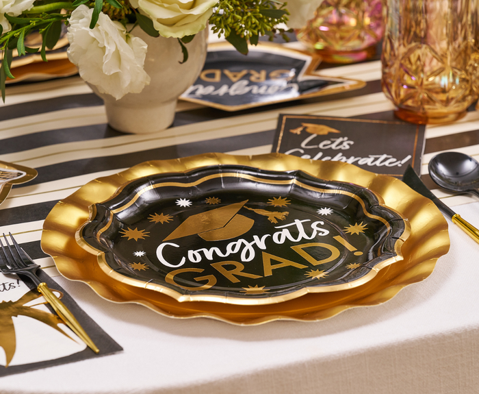 Create a festive table with Sophistiplate Classic Grad Dinner Plates (8pk), featuring a graduation cap design. Pair with gold utensils, a striped tablecloth, and cards for the perfect celebratory look at your graduation event.