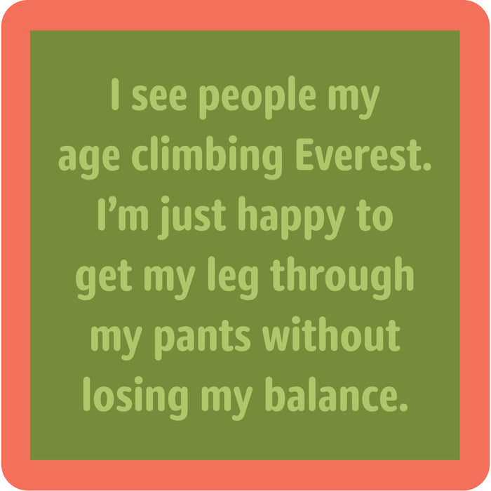 A green square coaster with a red border from Drinks On Me’s Coaster Bundle: Birthday features the funny text: “I see people my age climbing Everest. I’m just happy to get my leg through my pants without losing my balance.” Great for gifts or your collection.