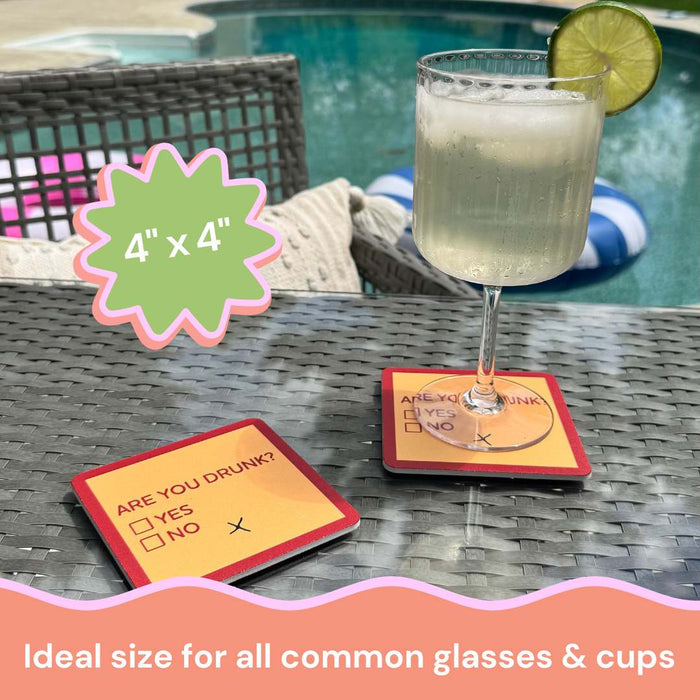 A glass with a lime wedge rests by the pool on our Drinks On Me Coaster Bundle: Are You Drunk? The coaster reads ARE YOU DRUNK? □ YES □ NO with an X below. Great gift for friends—measures 4" x 4", ideal for all common glasses and cups.