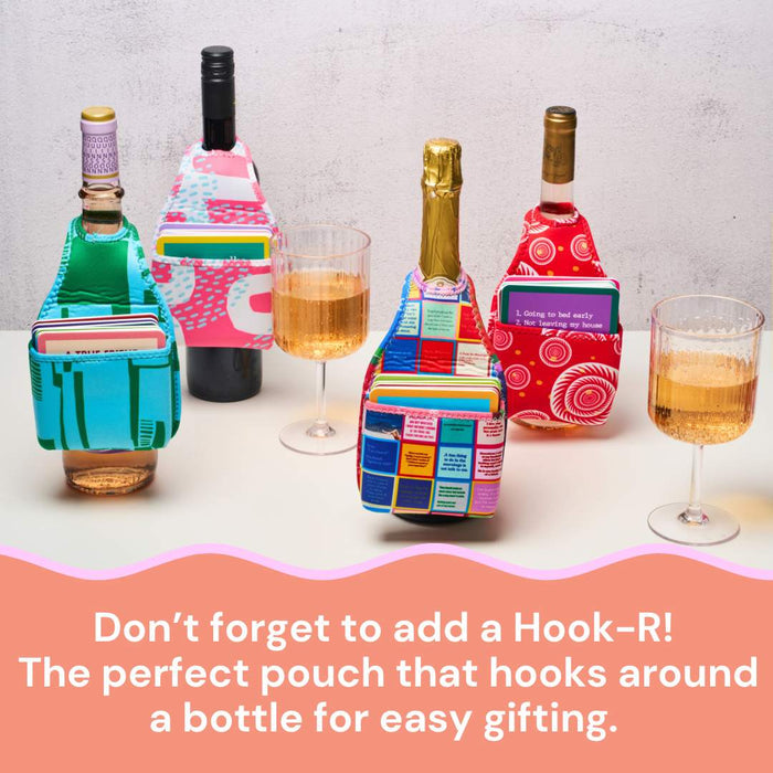 Three wine bottles with colorful pouches stand by filled glasses. Text reads: Don’t forget Drinks On Me’s Coaster Bundle: Best Sellers—the perfect party gift pouch that hooks around a bottle for easy gifting.