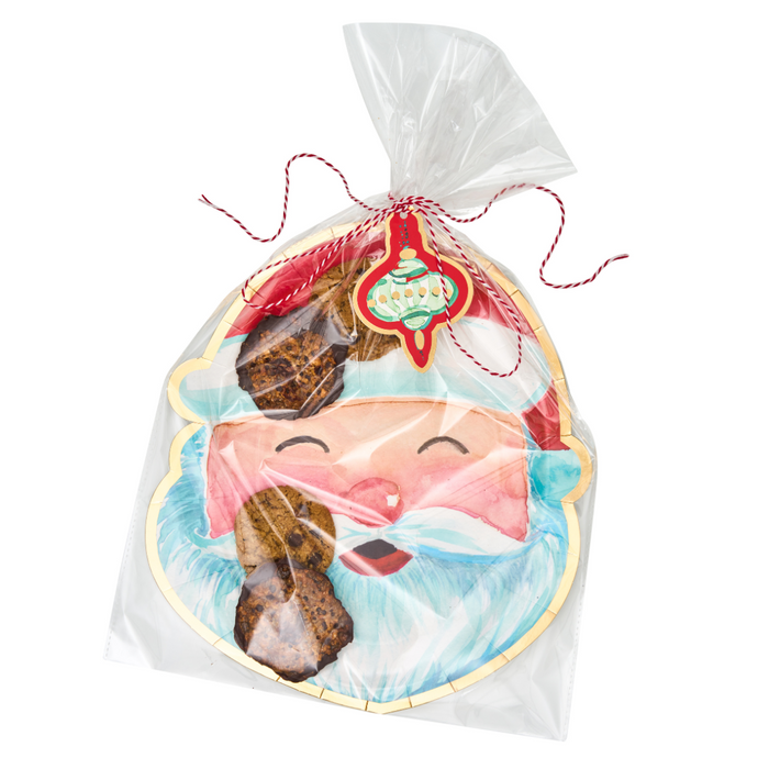 The Sugarplum Cookie Tray Gifting Kit Santa/6pkg features Santa-shaped cookies in clear wrap with festive string and an ornament tag—chocolate pieces inside make them a tasty, charming addition to your holiday treat exchange or Christmas cookie tray.