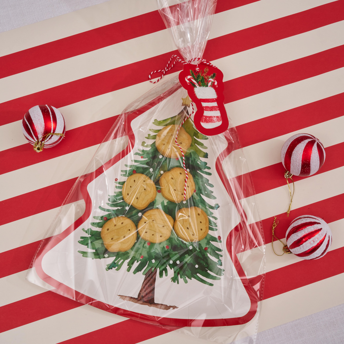 The Sugarplum Cookie Tray Gifting Kit Tree/6pkg features a tree-shaped tray filled with cookies, wrapped with a red-and-white string and felt stocking—perfect for any holiday treat exchange.