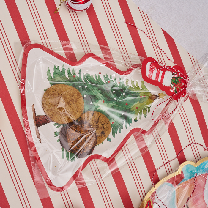 The Sugarplum Cookie Tray Gifting Kit Tree/6pkg features a tree-shaped tray filled with cookies, wrapped in clear plastic, and tied with red and white ribbon—ideal for your next holiday treat exchange.