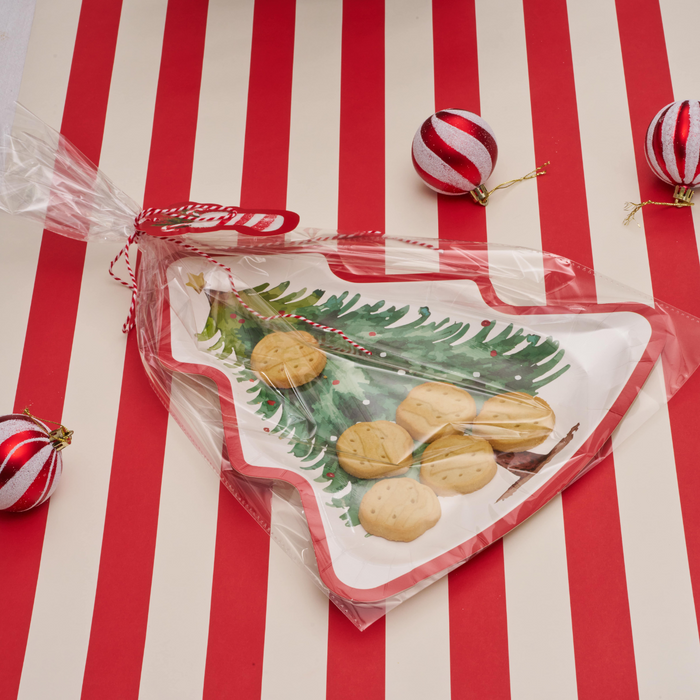 The Sugarplum Cookie Tray Gifting Kit Tree/6pkg features a tree-shaped tray of cookies wrapped in clear plastic with red and white string, surrounded by three matching ornaments—ideal for holiday treat exchanges.