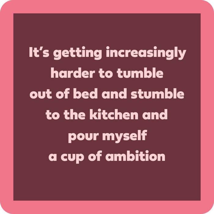 The Cup of Ambition Coaster by Drinks On Me features white text on a dark mauve background with a pink border—perfect as a funny bar cart accessory or unique housewarming gift.