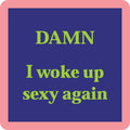 The Damn Coaster by Drinks On Me features a square design with a pink border, blue background, and bold light green text: DAMN I woke up sexy again—perfect for adding humor to your drinkware or bar cart.