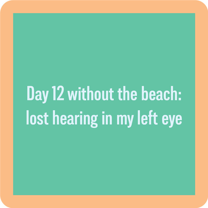 The Day 12 Coaster by Drinks On Me features a green square with a peach border and the text: "Day 12 without the beach: lost hearing in my left eye." A quirky gift for funny drink coaster lovers or housewarmings.