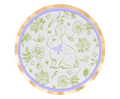 The Ultimate Easter Tablescape for 16: Easter Toile by Sophistiplate LLC features designer plates with a green rabbit and lavender bow among flowers, finished with a lavender border and gold rim—perfect for your Easter celebration.