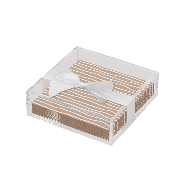 The Sophistiplate Eco Cocktail Napkin with Napkin Tray features a modern acrylic holder with beige, white-striped cocktail napkins tied in a white ribbon bow, set against a plain white background.
