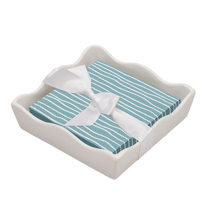 The Sophistiplate Eco Cocktail Napkin with Napkin Tray features blue striped napkins tied with a white satin ribbon, all elegantly arranged on a white ceramic tray—an ideal modern tabletop accent.