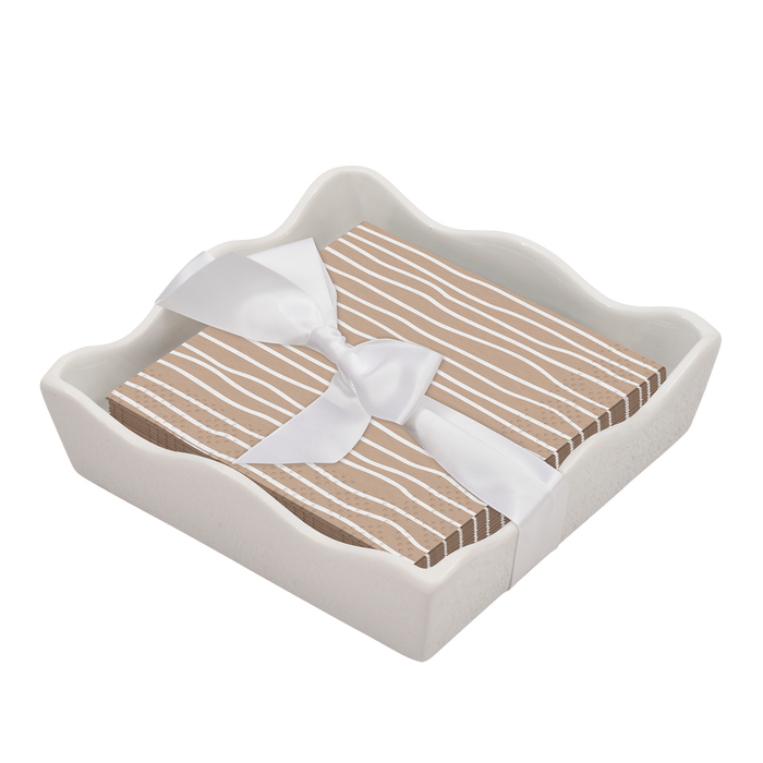The Sophistiplate Eco Cocktail Napkin with Napkin Tray features a stack of beige and white striped napkins, neatly arranged in a modern ceramic holder and tied with a satin ribbon for an elegant tabletop look.