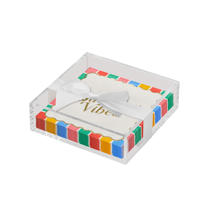The Sophistiplate Everyday Cocktail Napkin with Napkin Tray includes a clear holder displaying white napkins with colorful scalloped edges, gold text, and a white satin ribbon.